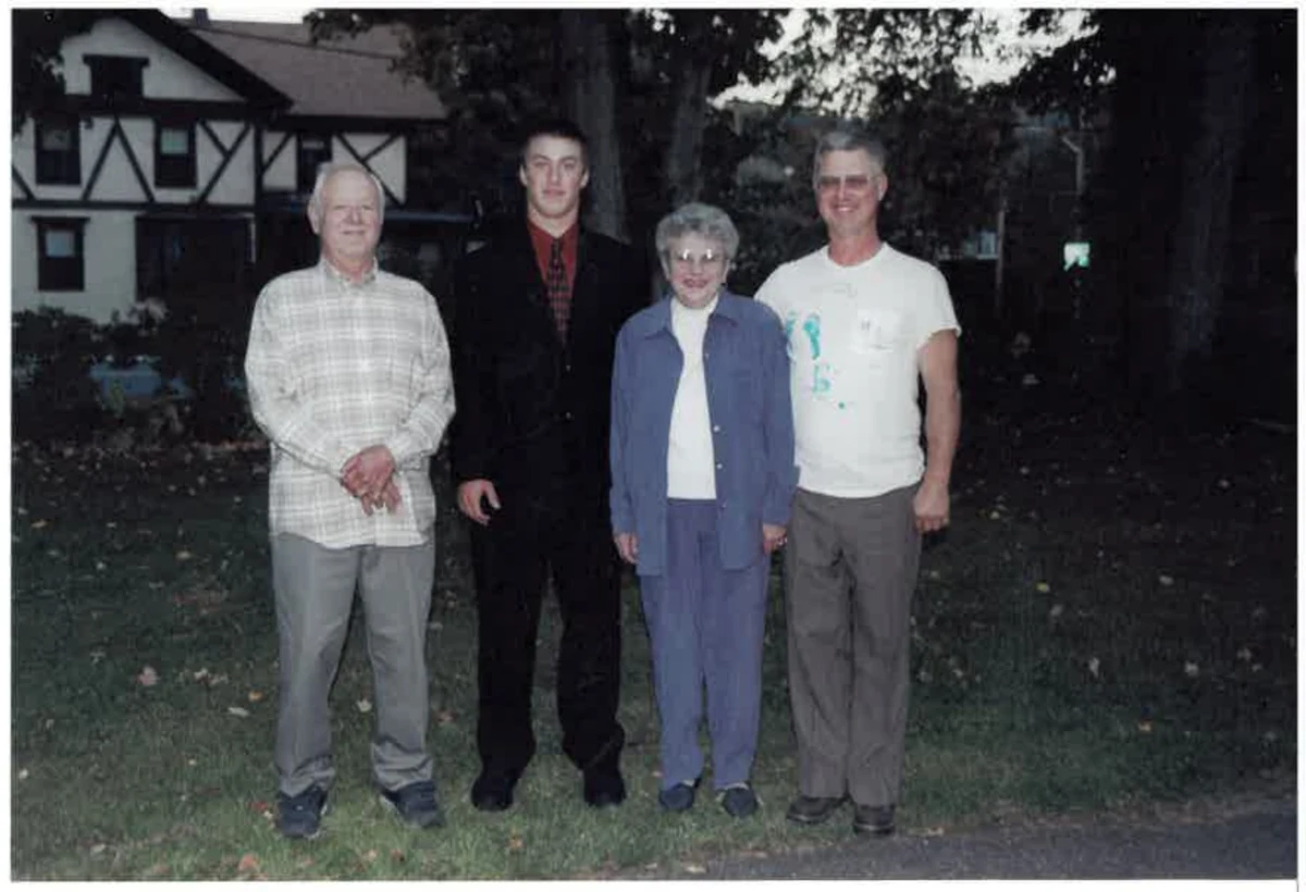 Four family members standing together outdoors in an older family photograph