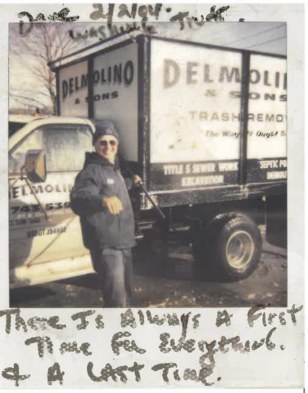 A person standing beside an older Delmolino and Sons truck; handwritten notes frame the photograph
