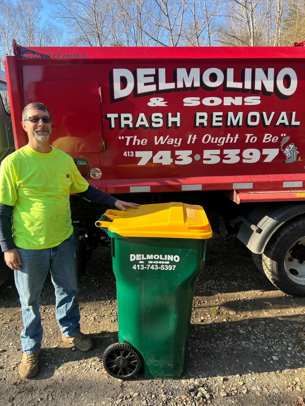 Delmolino & Sons team member with a collection tote beside a company truck